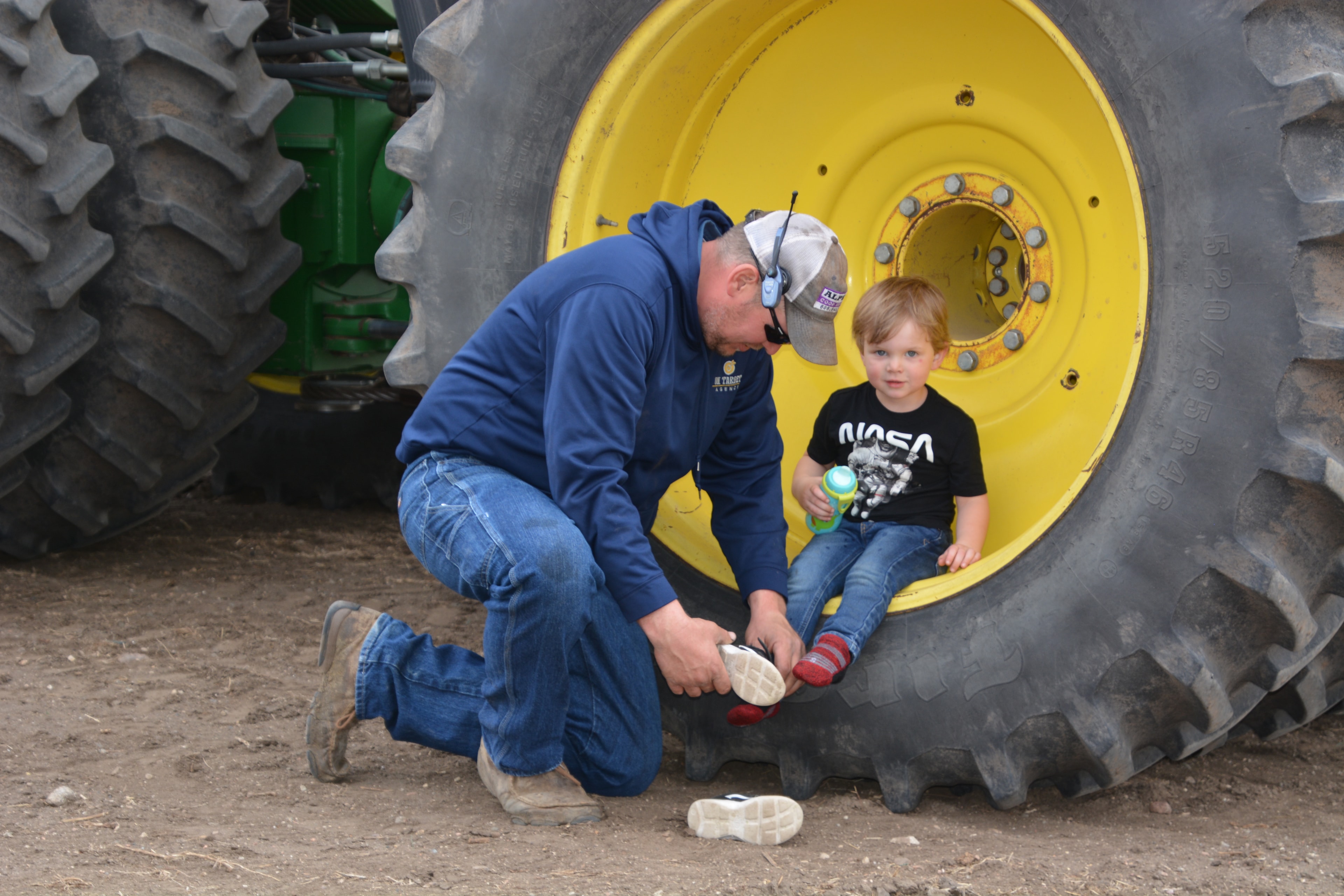 Father and child beside a tractor on the farm